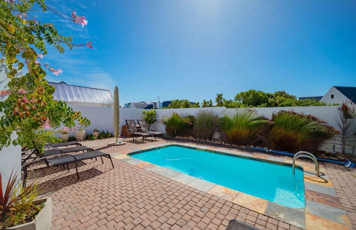 Private pool with loungers and indigenous planting